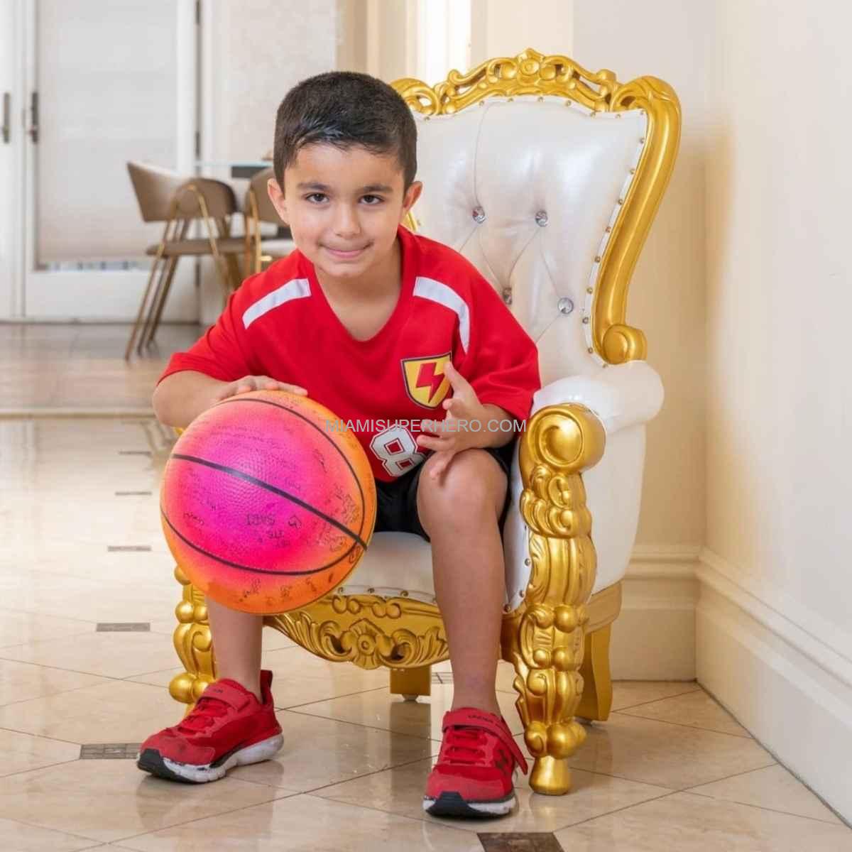 Baby throne rental setup with toddler at birthday party
