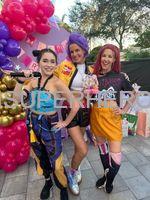 K-Pop Demon Hunter characters Rumi, Zoey, and Mira posing at a birthday party