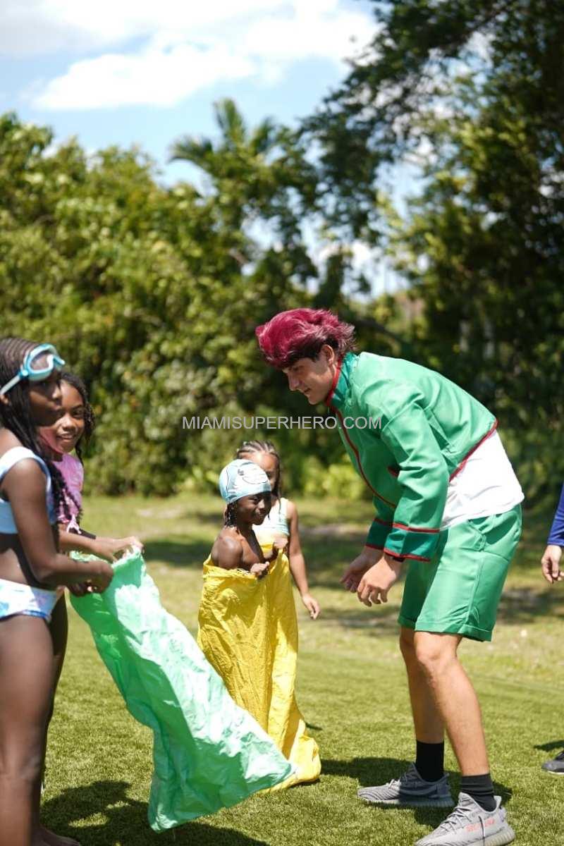 Gon helping kids with a sack race at a Cooper City backyard party